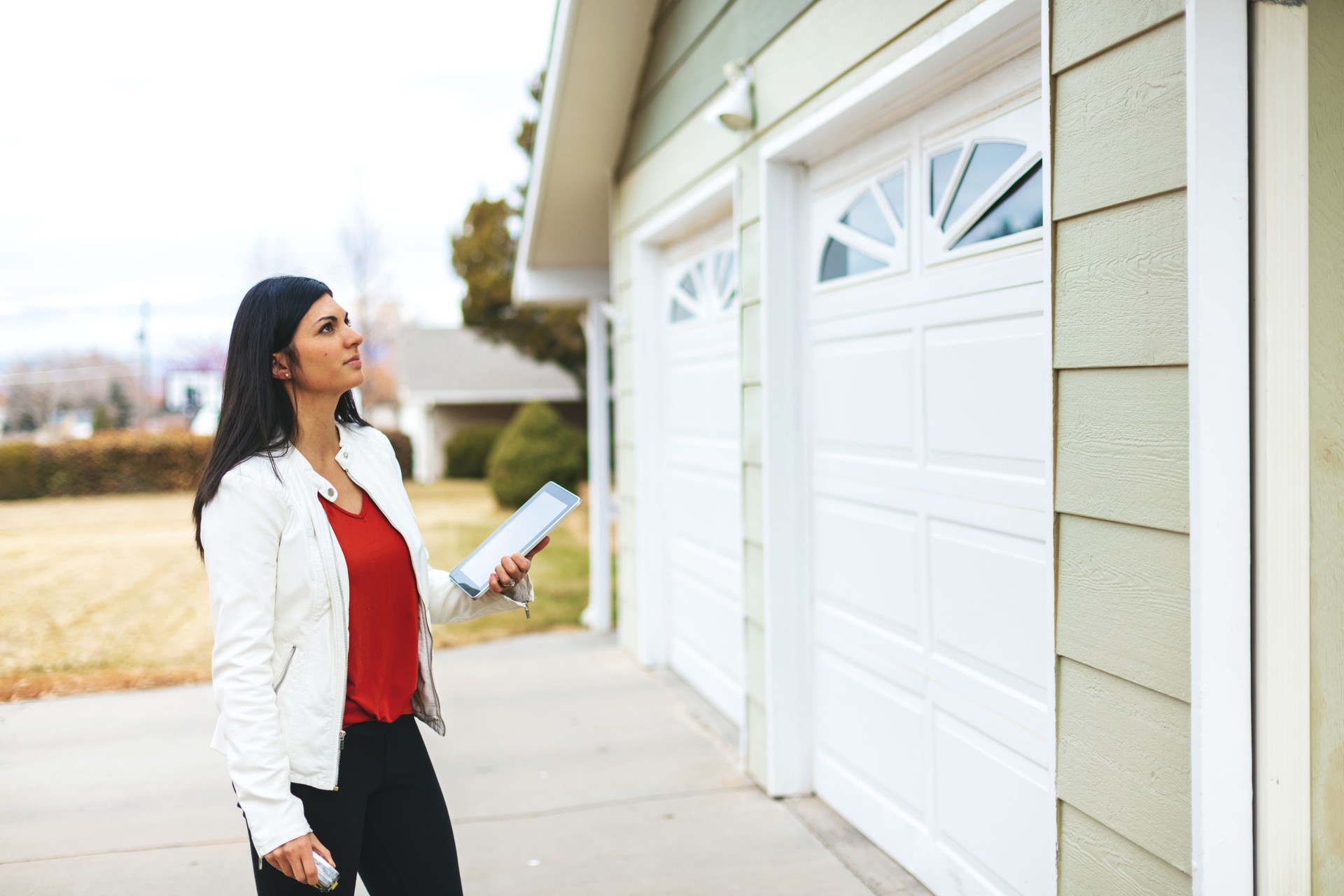 Young Adult Millennial Female Appraiser Measuring Home Features and Assessing Value in Western Colorado