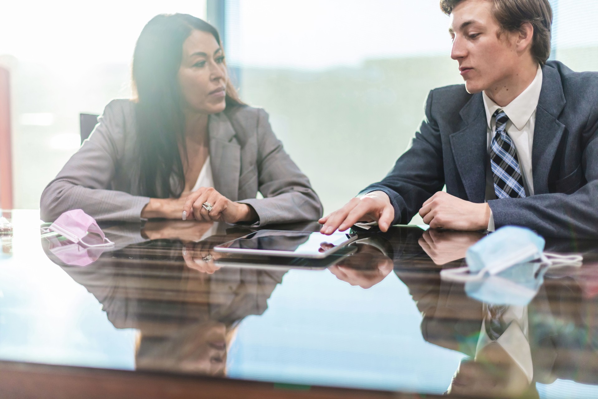 Mature Adult Female and Millennial Male in Professional Office Setting During Pandemic Photo Series
